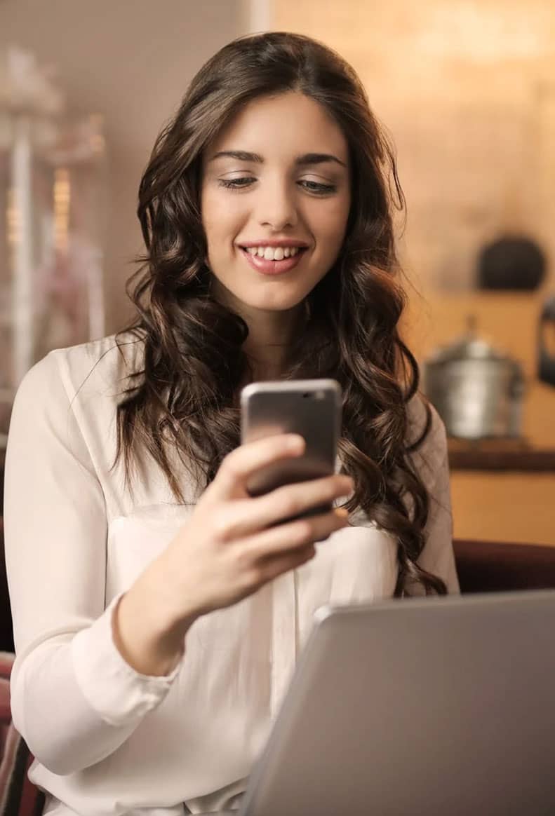 Woman Smiling at Phone